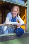 Dutch Woman In Old-fashioned Clothes Holding Hat In Train Window Stock Photo