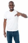 Smiling Man Pointing At Blank White T-shirt Stock Photo