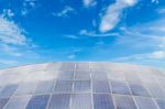 Solar Panels Against Blue Sky Background Stock Photo