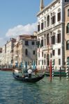 Gondolier Ferrying People In Venice Stock Photo