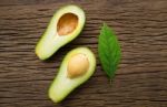 Avocado On A Brown Wood Background Stock Photo