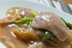 Rad Na, Famous Thai Chinese Style Wide Rice Noodle Dish With Tasty Tender Pork With Thick Gravy Sauce. Close Up Stock Photo