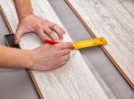 Man Laying Laminate Flooring Stock Photo