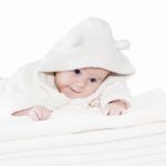 Blue Eyes Baby Boy On White Towels Stock Photo