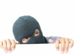 Robber Hiding Under A White Wall Stock Photo