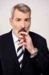 Businessman Smoking Cigar Stock Photo