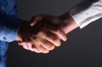 Handshake Handshaking In Dark With Low Light Stock Photo