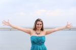 Beautiful Woman With Open Arms Looking At The Camera Stock Photo