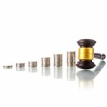 Judges Law Gavel With Coins Stock Photo