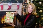 Blonde Female Holding Gift In Holiday Scene Stock Photo