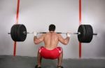 The Concept Of Power And Determination Of A Man Lifting A Weight Stock Photo