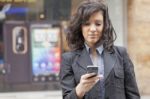 Lady Reading Sms In Street Stock Photo