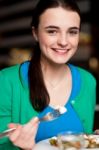 Happy Young Girl Enjoying Her Dinner Stock Photo