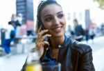 Beautiful Young Woman Using Her Mobile Phone In The Street Stock Photo