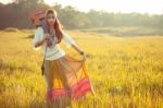 Hippie Woman Walking In Golden Field Stock Photo