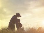 Mother And Daughter On Sunset Watching On Sky Stock Photo