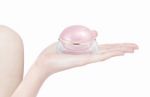 Pink Dome Cosmetic Jar On Hand Isolated Stock Photo