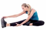 Fit Woman Stretching While Exercising Stock Photo