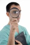 Smart Surgeon Holding Magnifier Stock Photo