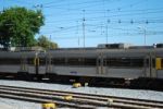 Gray Train Passing A Local Village Stock Photo