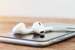 Closeup Phone And Headphone Device On Table Stock Photo