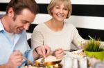 Couple Enjoying Breakfast In Restaurant Stock Photo