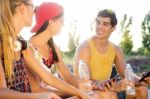 Group Of Friends Texting With Their Smart Phones In The Park Stock Photo