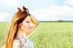 Woman At Wheat Field On Sunny Day Stock Photo