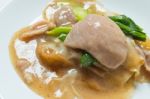 Rad Na, Famous Thai Chinese Style Wide Rice Noodle Dish With Tasty Tender Pork With Thick Gravy Sauce. Close Up Stock Photo