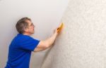 Elderly Worker Smoothing Wallpaper Stock Photo