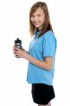 Girl Holding Sipper Bottle. Break From Gym Workout Stock Photo