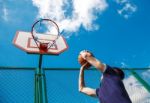 Young Man Playing Basketball Stock Photo