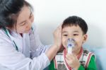 Asian Boy Having Respiratory Illness Helped By Health Professional In Hospital Stock Photo