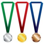 Three Medals Set. Gold, Silver And Bronze On Red Ribbon And Green, Blue Ribbon Stock Photo