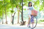 Young Woman Bicycling Stock Photo