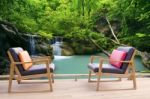 Relaxing Wooden Desk On Wood Terrace Against Beautiful Waterfall Stock Photo