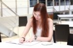 Portrait Of Thai Adult Beautiful Girl Write A Book And Smile In University Stock Photo