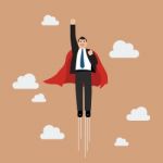 Businessman Superhero Flying Into The Sky Stock Photo