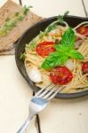 Spaghetti Pasta With Baked Cherry Tomatoes And Basil Stock Photo