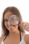 Smiling Model Holding Magnifying Glass Stock Photo