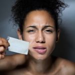 Black Woman With Mouth Covered With Tape. Concept Of Forbidden Opinion Stock Photo