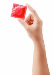 Condom In Female Hand Isolated On  White With Clipping Path Stock Photo