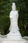 Kuan Yin Marble Sculpture Under Green Bamboo Background Stock Photo