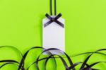 Gift Tag With Ribbon On Green Stock Photo