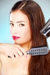 Woman Holding Blow Dryer And Comb Stock Photo