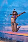 Beautiful Black African American Woman Jumping On The Beach At S Stock Photo