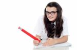 Schoolgirl Writing On Notebook Stock Photo