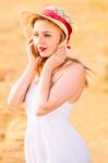 Lonely Beautiful Young Blonde Girl In White Dress With Straw Hat Stock Photo