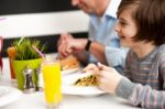 Dad And Son In Restaurant Stock Photo