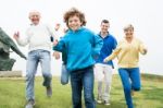 Happy Family Running At The Lawn Stock Photo